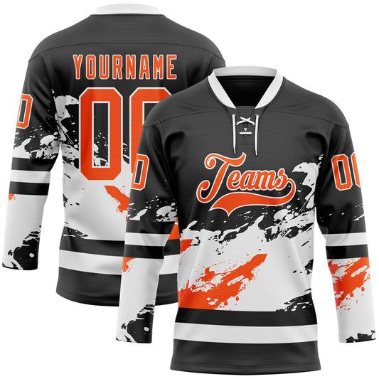 Custom Black Orange-White Abstract Splatter Paint Hockey Lace Neck Jersey - Main View